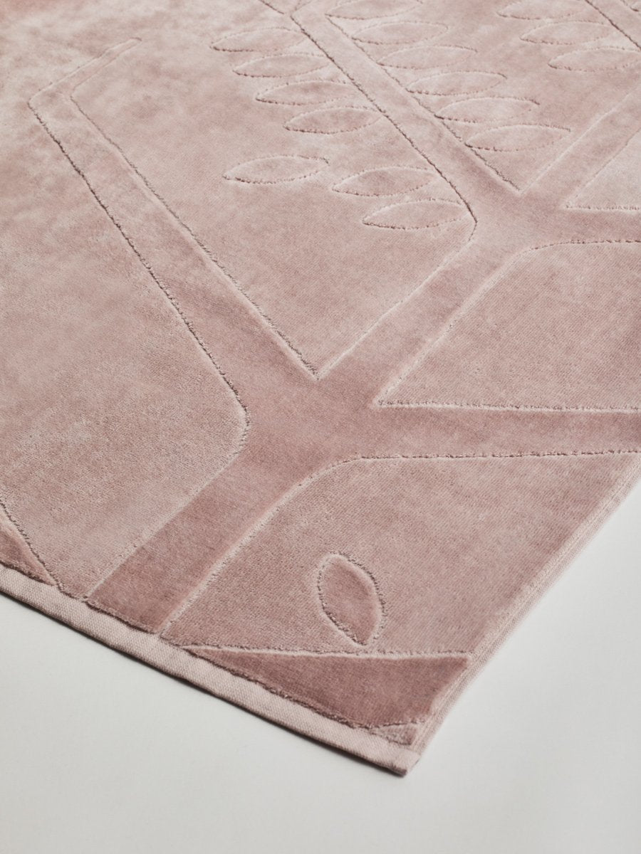 Close-up of a 'Hawaiian Sunrise' beach towel with a textured and embossed Four Seasons logo design. - {{Hawaiian Sunrise}}