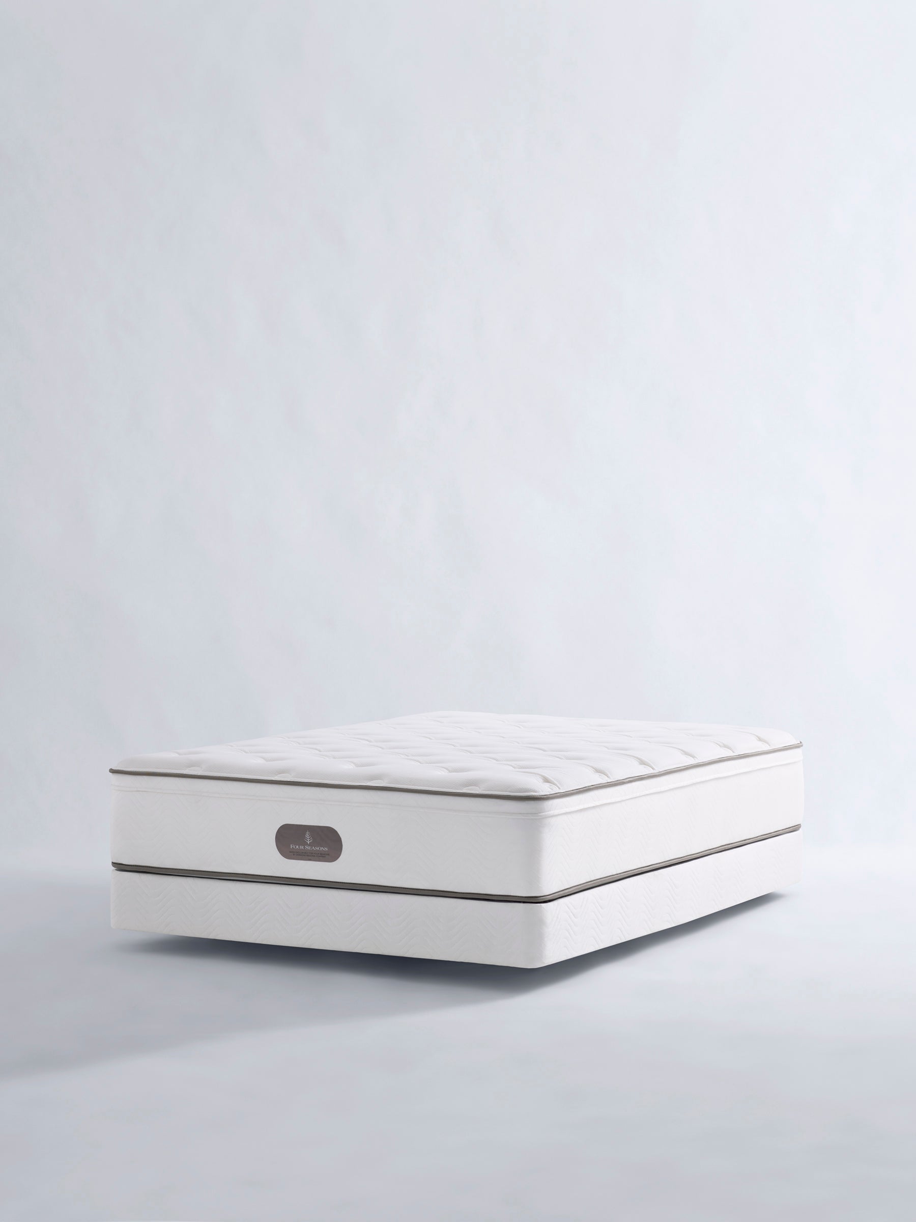Luxury white mattress with quilted details and brand label.