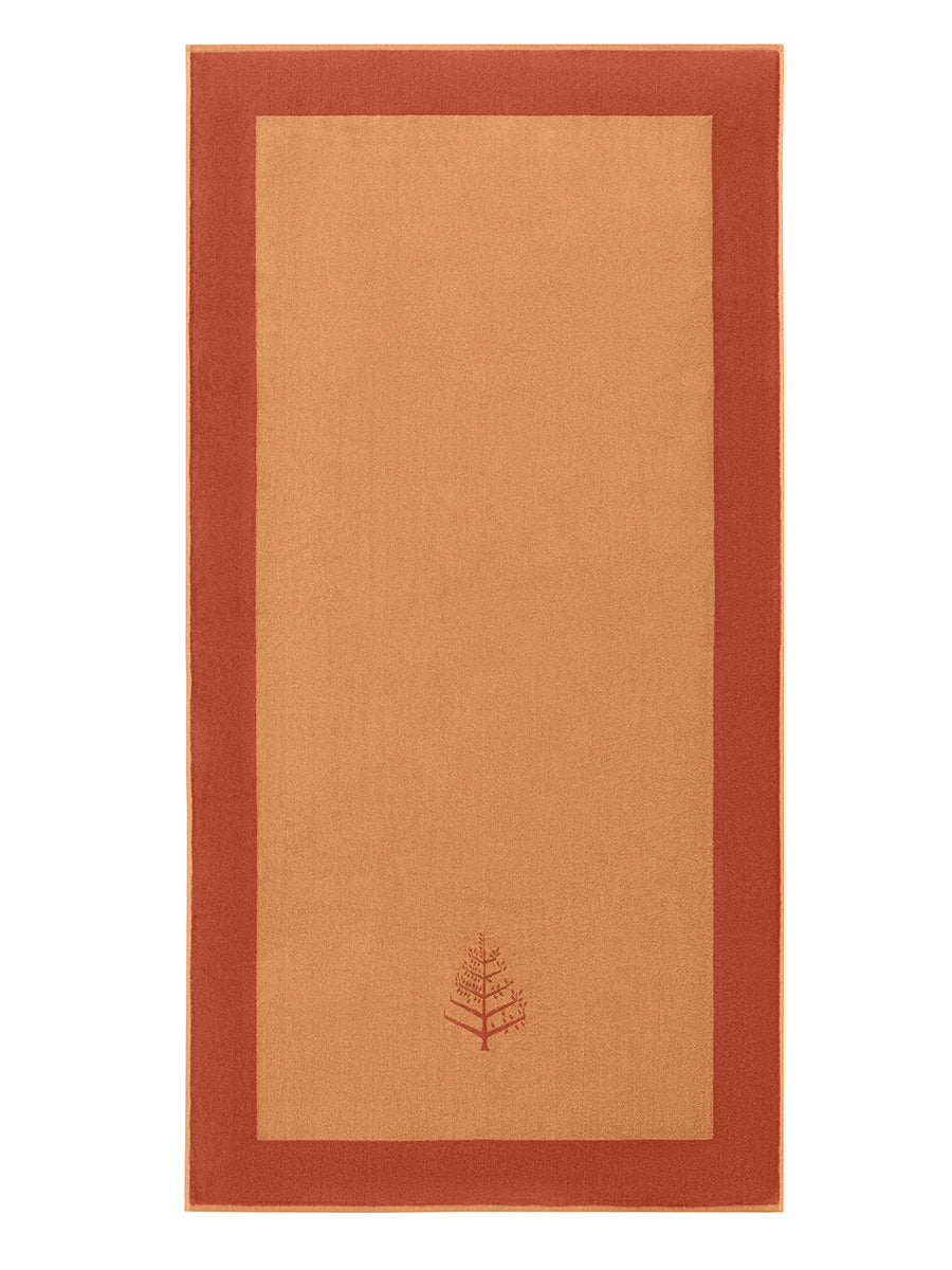 A "Arabian Terracotta" Resort Towel with a subtle embroidered Four Seasons logo. The towel features a darker border. - {{Arabian Terracota}}