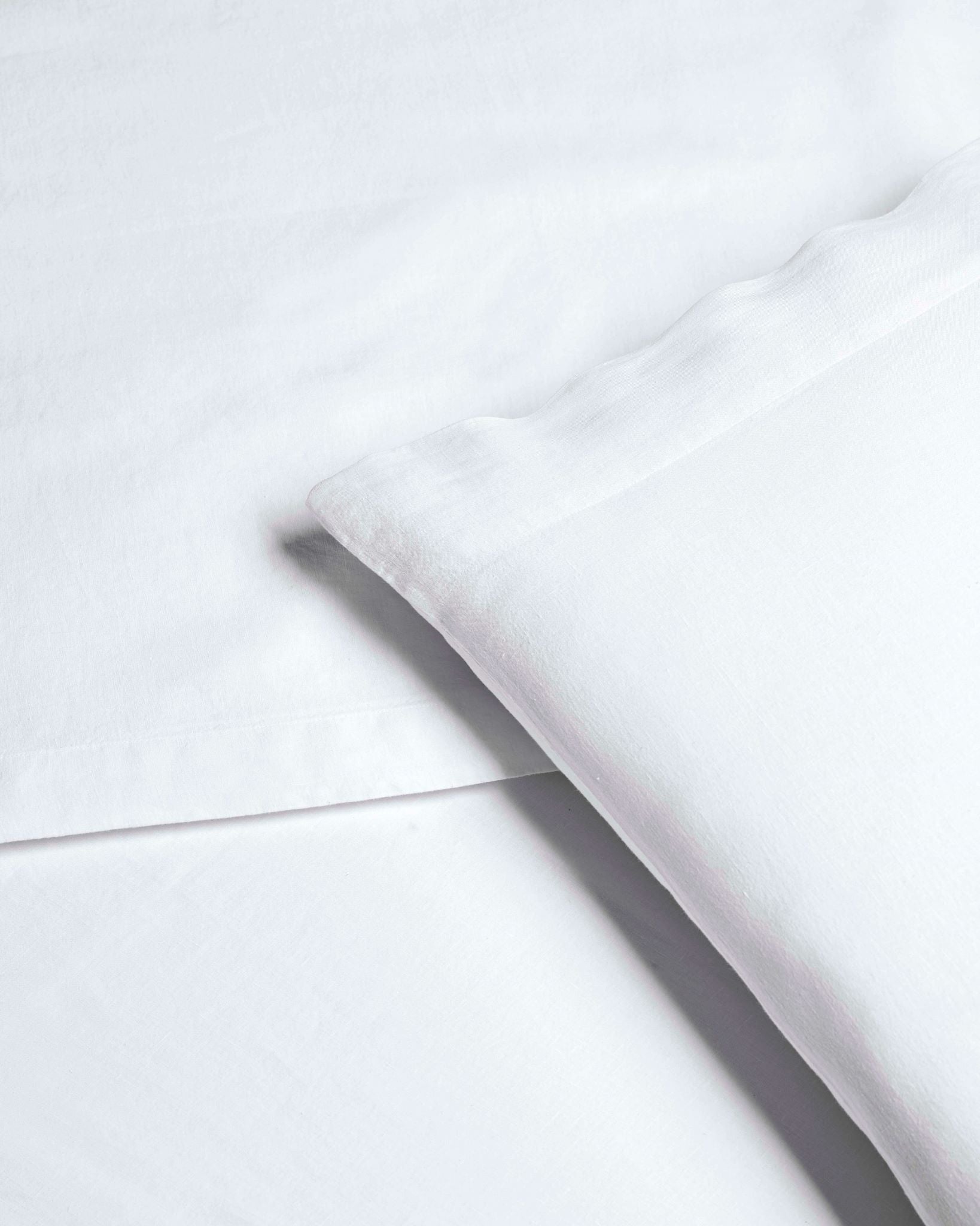 Acacia Linen Set in Signature White—detail of linen sheet and pillowcase with soft flange edge - {{Signature White}}