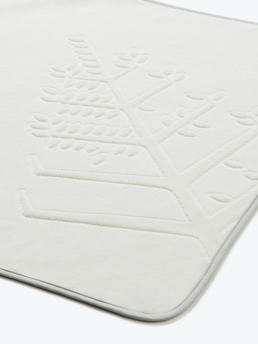 Close-up of a "Safari Sage" hooded baby towel with an embroidered Four Seasons logo. - {{Safari Sage / Mountain Grey}}