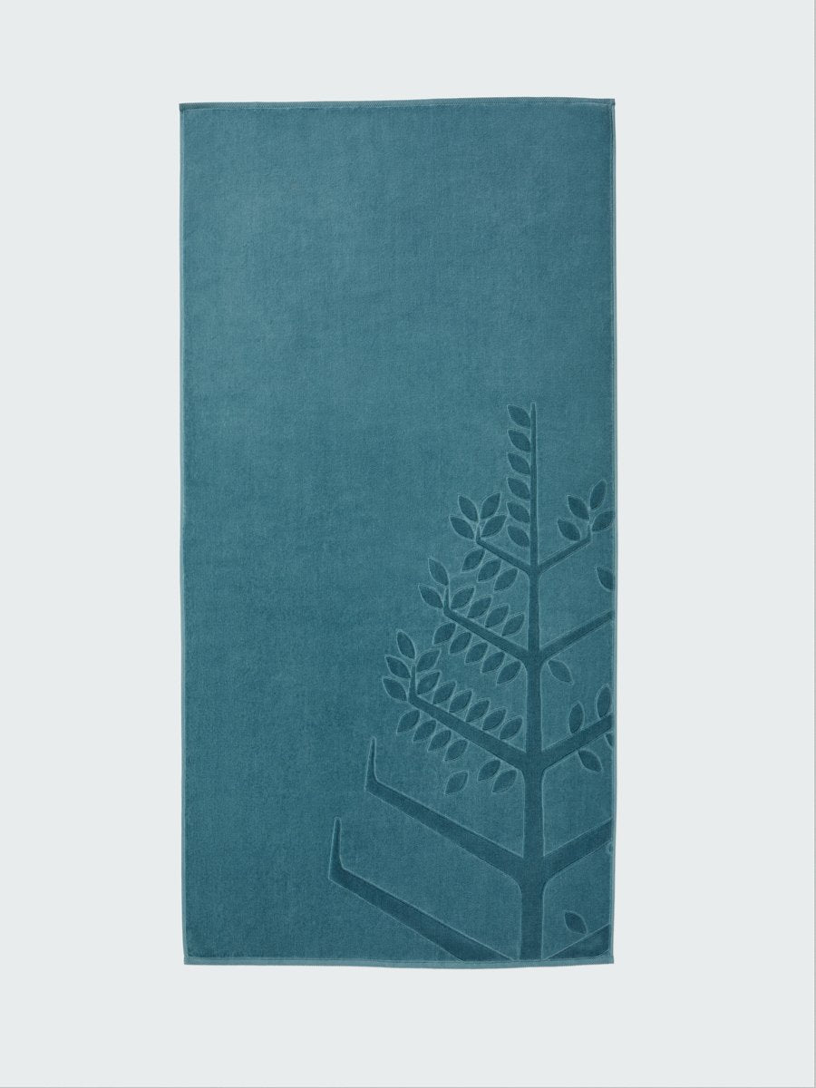 A 'Polynesian Lagoon' beach towel with the Four Seasons logo embossed on it. - {{Polynesian Lagoon}}