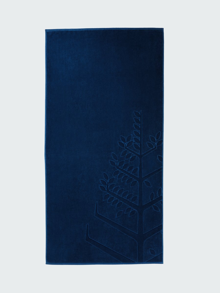 A 'Riviera Navy' beach towel with the Four Seasons logo embossed on it. - {{Caribbean Seascape}}