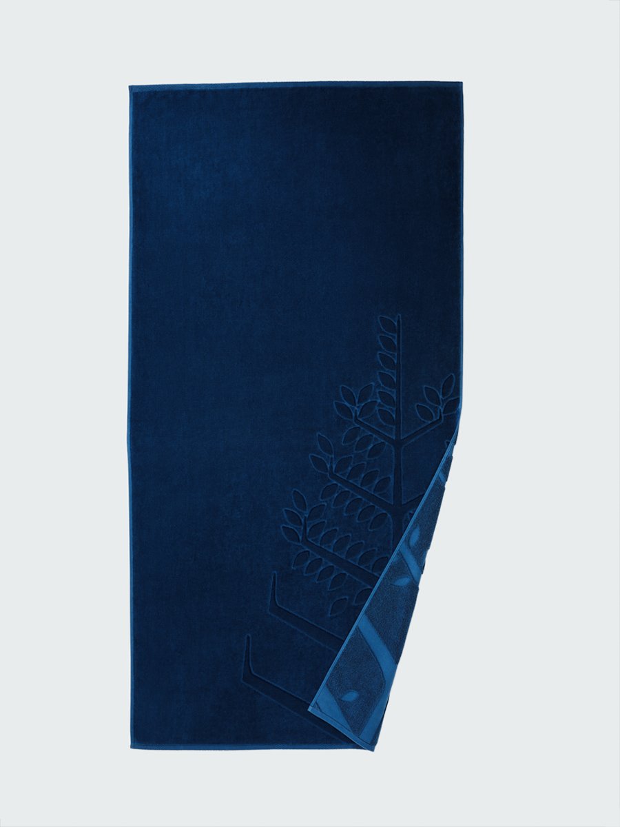 'Riviera Navy' beach towel with an embossed Four Seasons logo. Part of the towel is folded back to reveal the same design on the bottom. - {{Caribbean Seascape}}