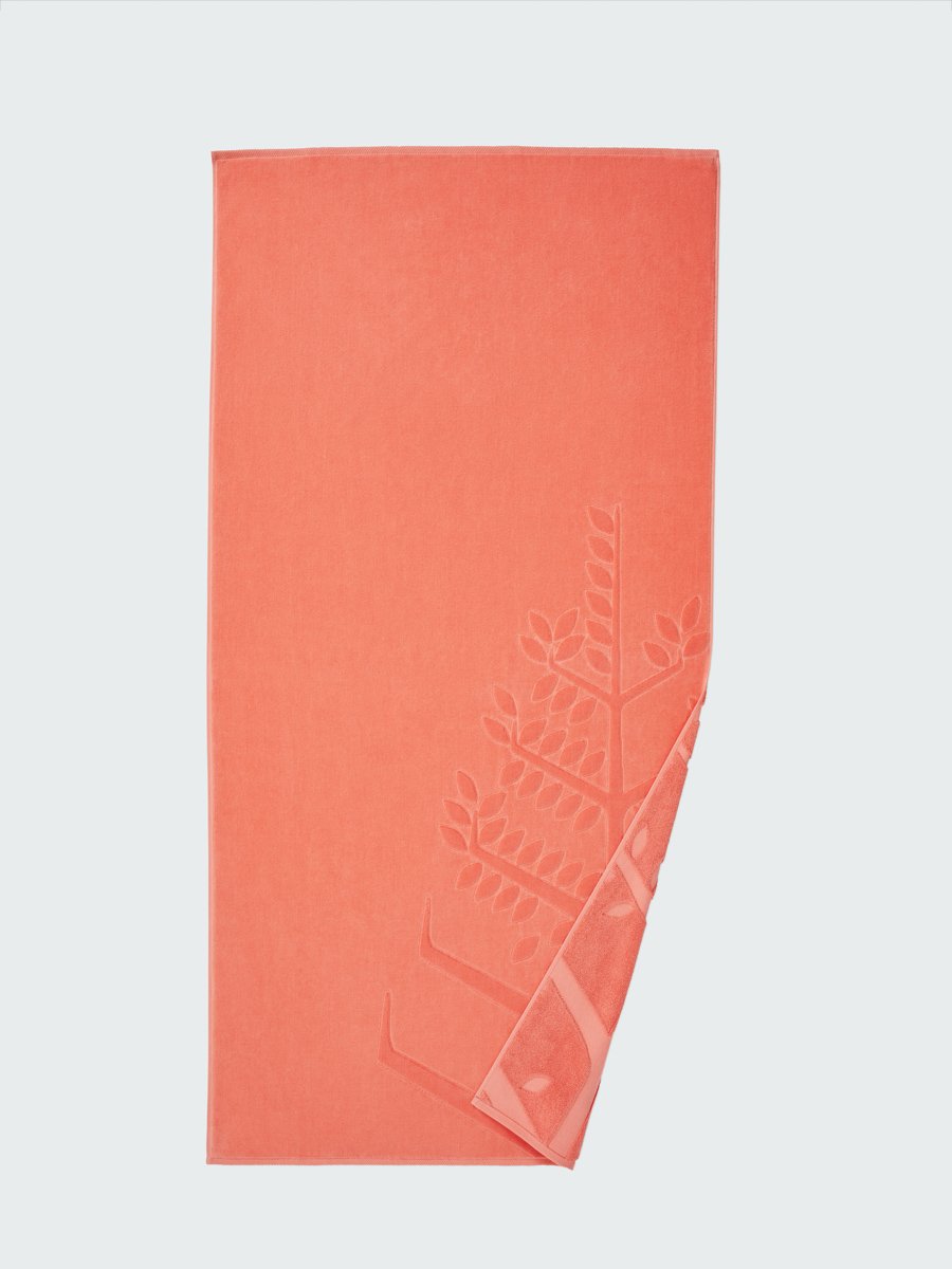 'Red Sea Coral' beach towel with an embossed Four Seasons logo. Part of the towel is folded back to reveal the same design on the bottom. - {{Red Sea Coral}}