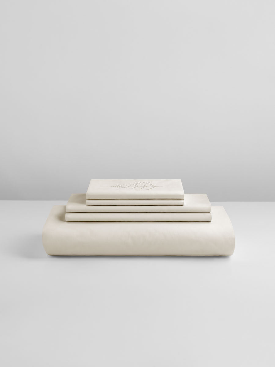 Balinese Pearl duvet cover set stacked: folded duvet and shams; top piece with tone-on-tone logo store embroidery. {{Balinese Pearl}}