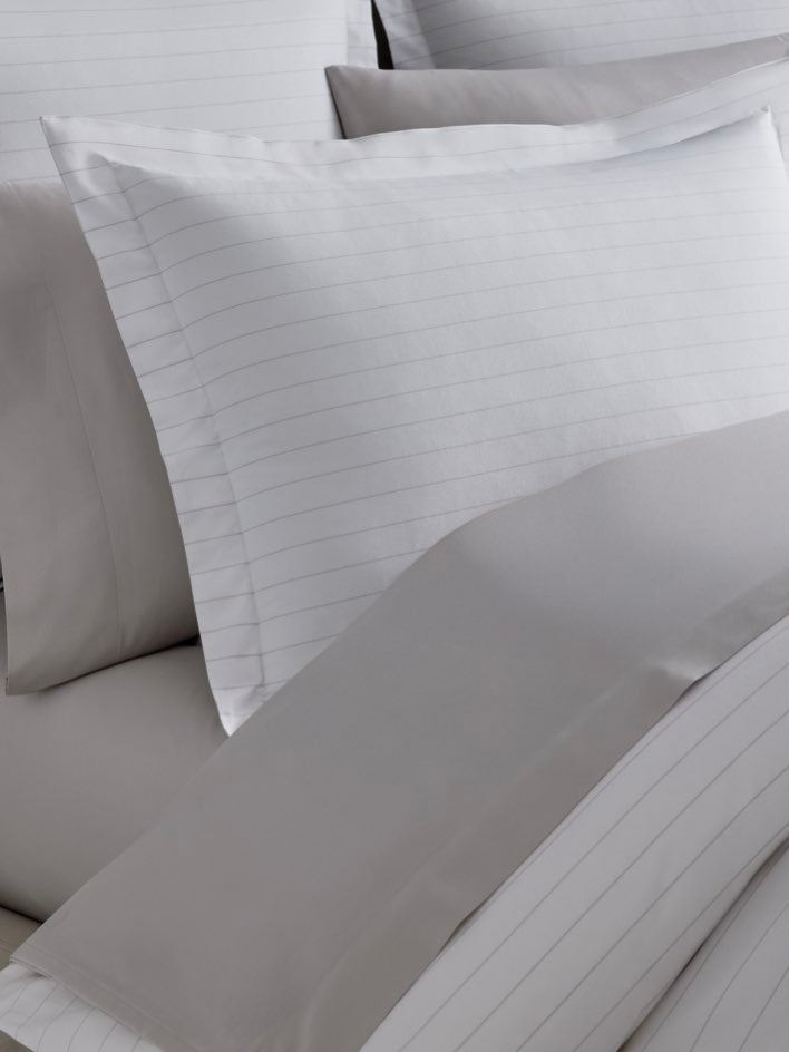 White pillowcase with thin gray stripes on a Signature White/Turkish Silver colored duvet cover. - {{Signature White/Turkish Silver}}