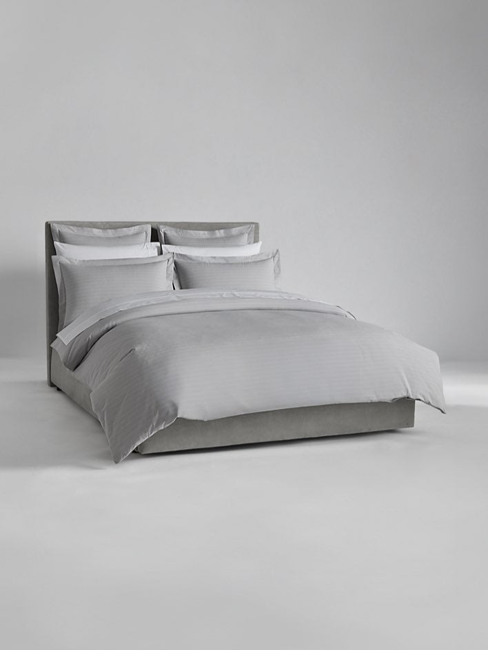 Luxury bed dressed with Turkish Silver/Signature White sheets and duvet. - {{Turkish Silver/Signature White}}