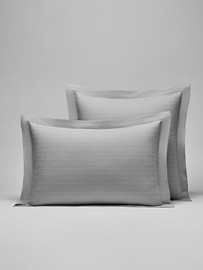 Two pillows with a subtle striped design in Turkish Silver/Signature White colors. - {{Turkish Silver/Signature White}}