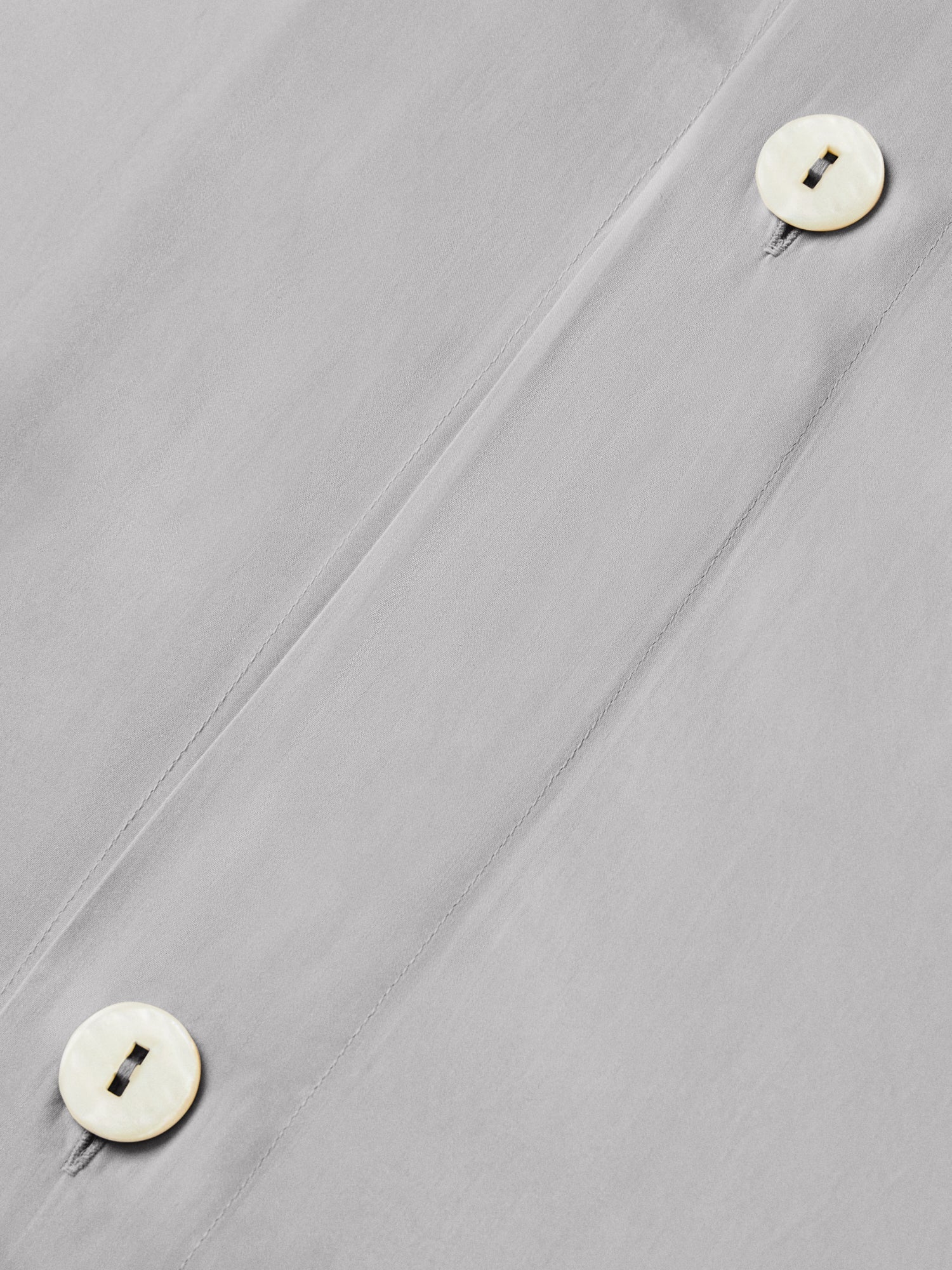 Close-up of Turkish Silver duvet cover showing concealed button placket with two pearlescent buttons. {{Turkish Silver}}