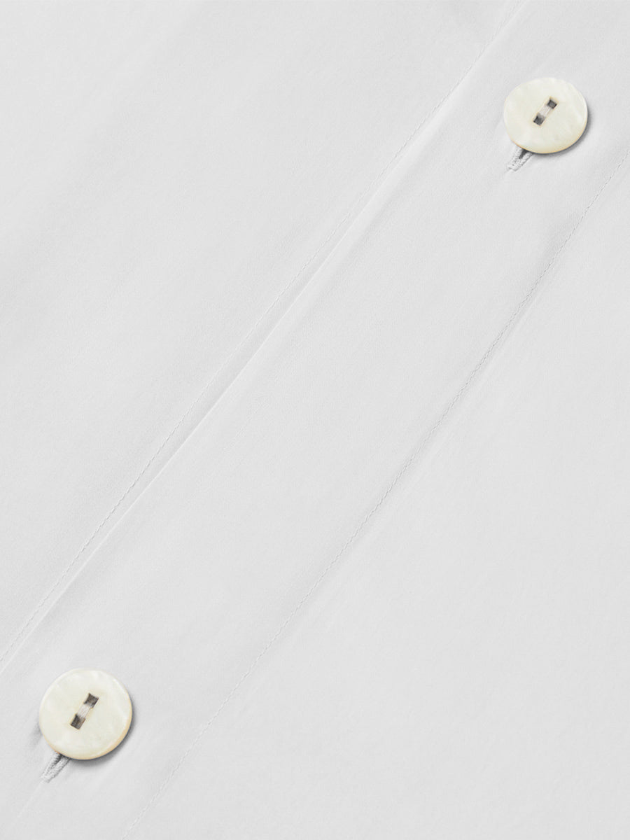 Close-up of Signature White duvet cover with hidden button closure detail. {{Signature White}}