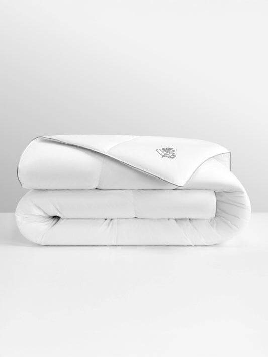 White pure down duvet folded with a Four Seasons logo on a light gray background.