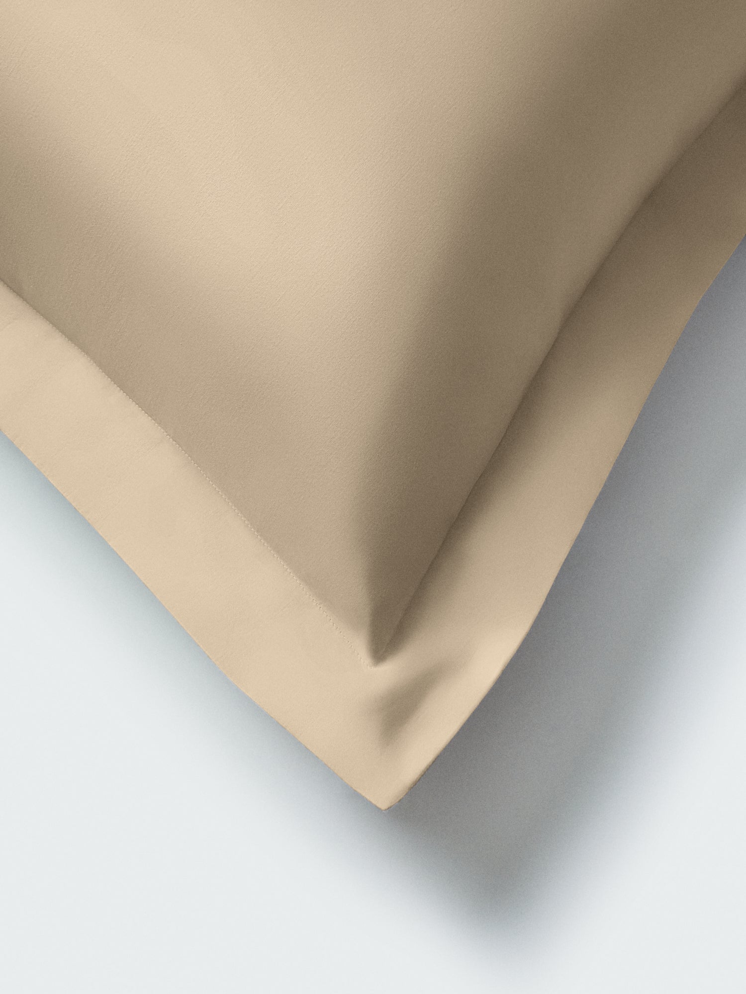 Close-up of Egyptian Camel euro sham corner showing mitered flange and smooth cotton sateen fabric on a light surface. {{Egyptian Camel}}