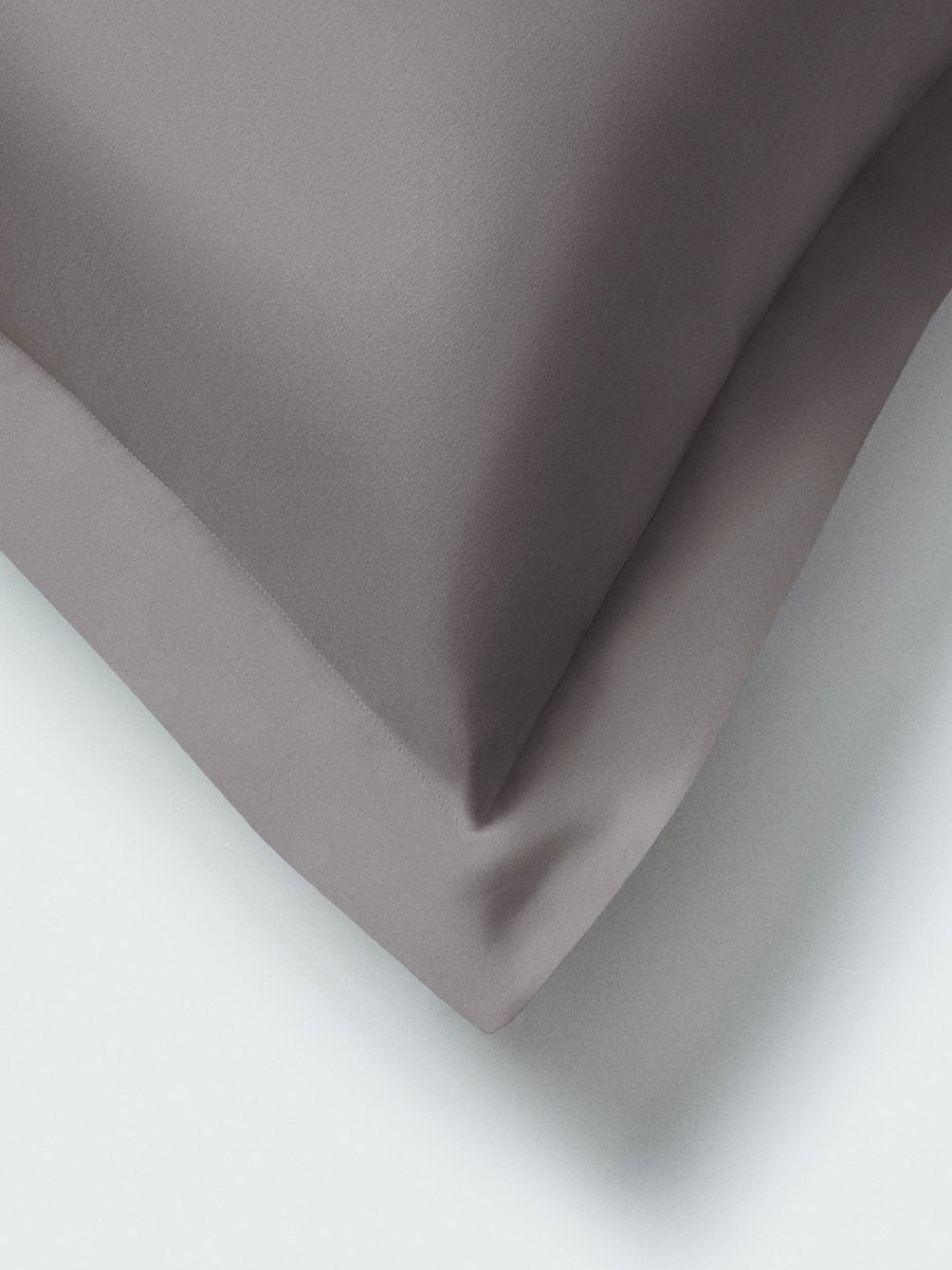 Part of a pillow with a Hampshire Charcoal color pillowcase featuring embroidery along the edge. - {{Hampshire Charcoal}}
