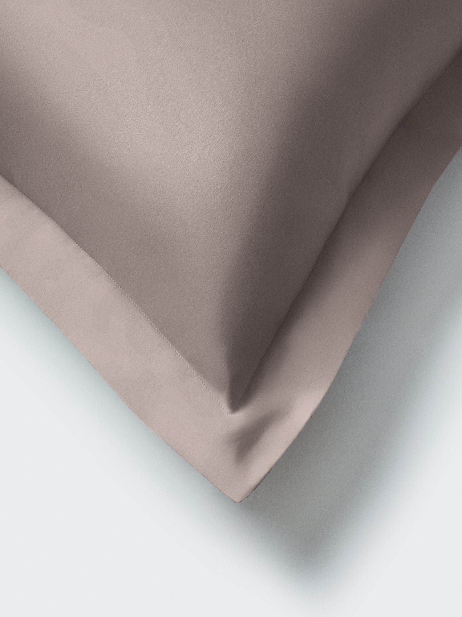 Close-up of a euro sham corner in Moroccan Sand color, highlighting the stitched flange and smooth fabric. {{Moroccan Sand}}