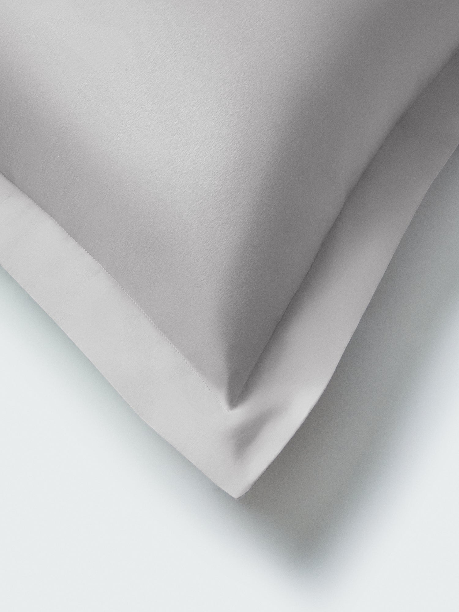 Close-up of Turkish Silver Euro pillow sham corner with flange border and soft shadow. {{Turkish Silver}}