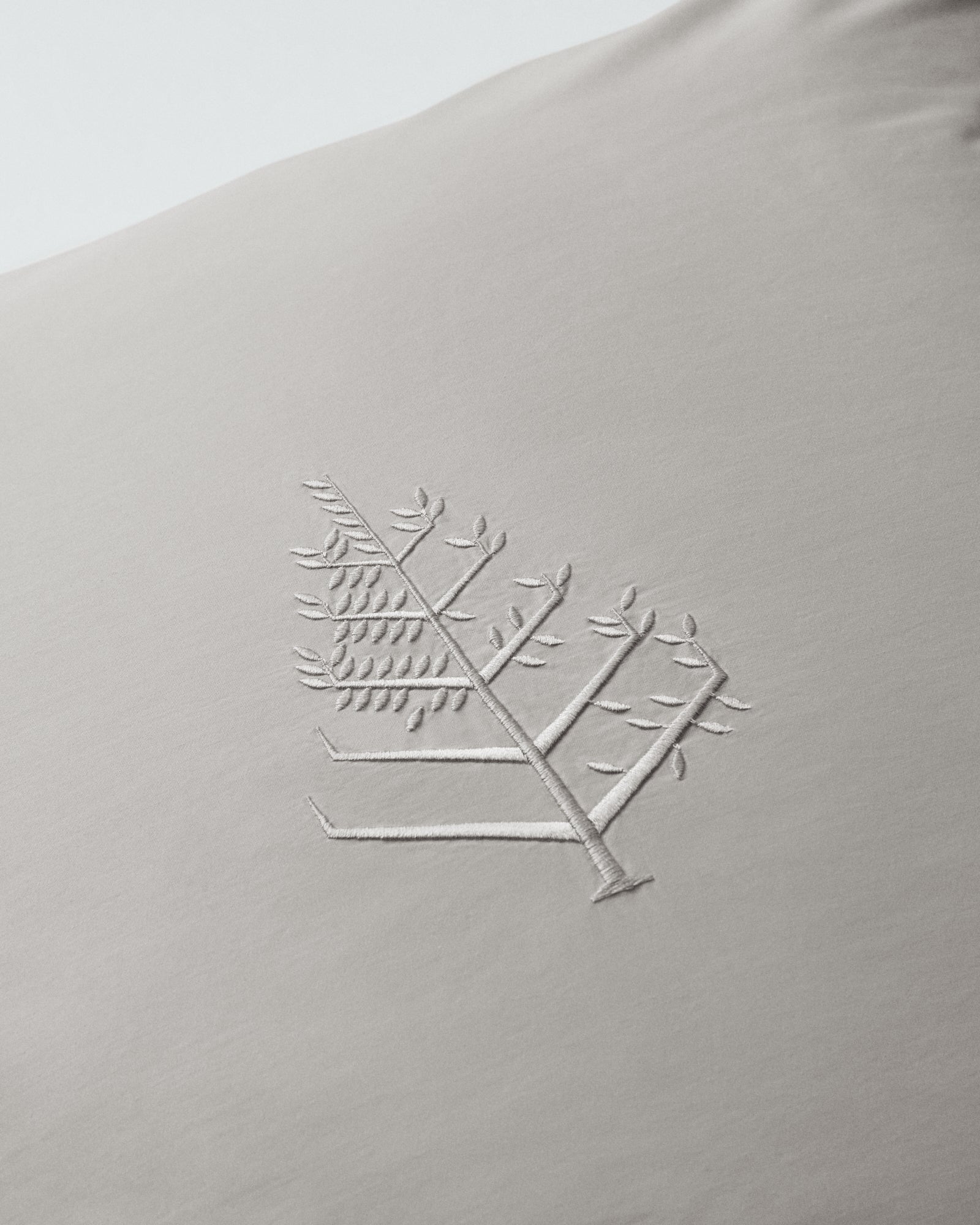 Close-up of Spanish Slate Euro sham with tone-on-tone logo store embroidery. {{Spanish Slate}}