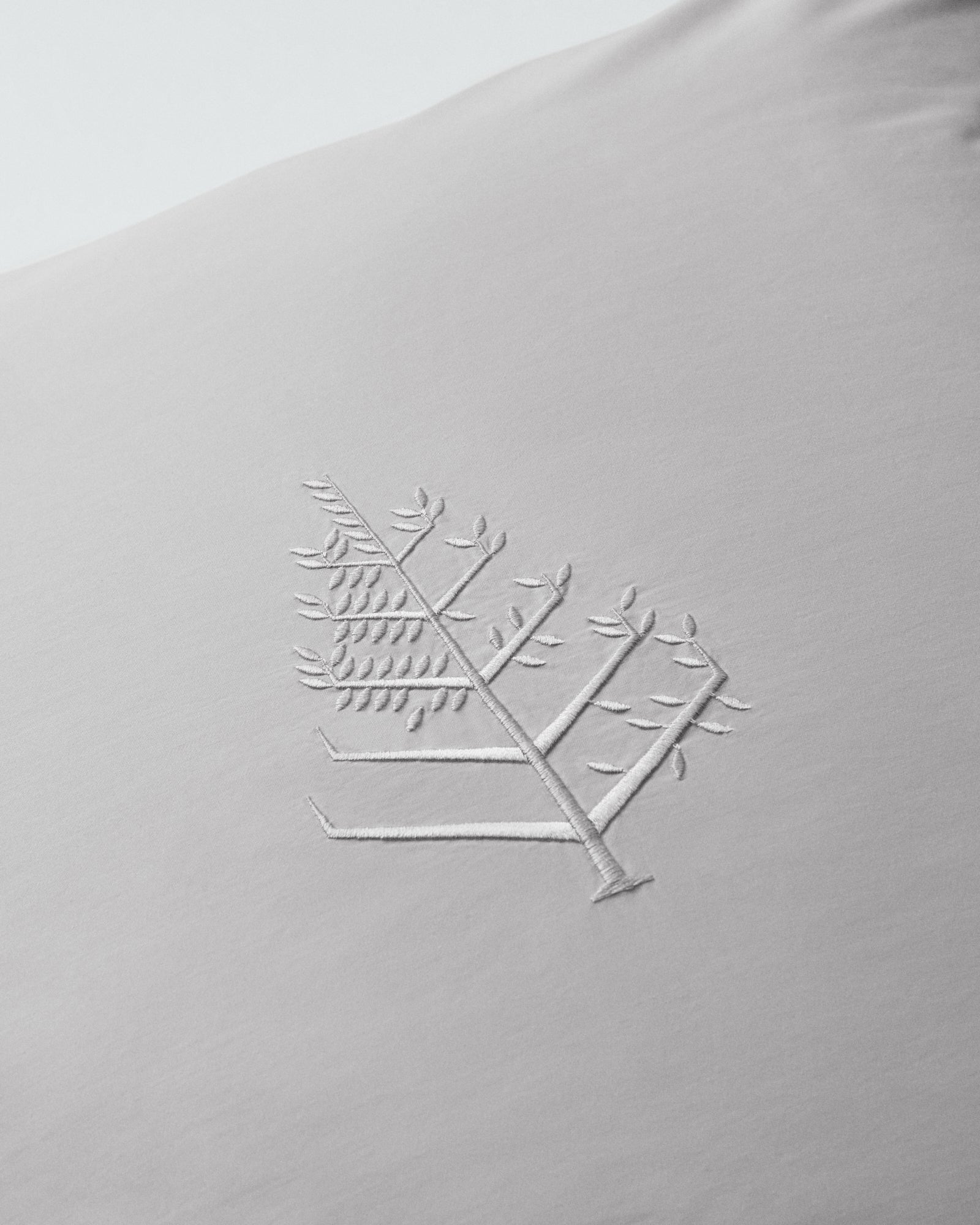 Close-up of Turkish Silver euro sham showing embroidered store logo. {{Turkish Silver}}