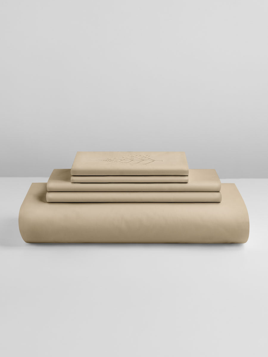 Egyptian Camel duvet cover set stacked: folded duvet and shams; top piece with tone-on-tone logo store embroidery. {{Egyptian Camel}}