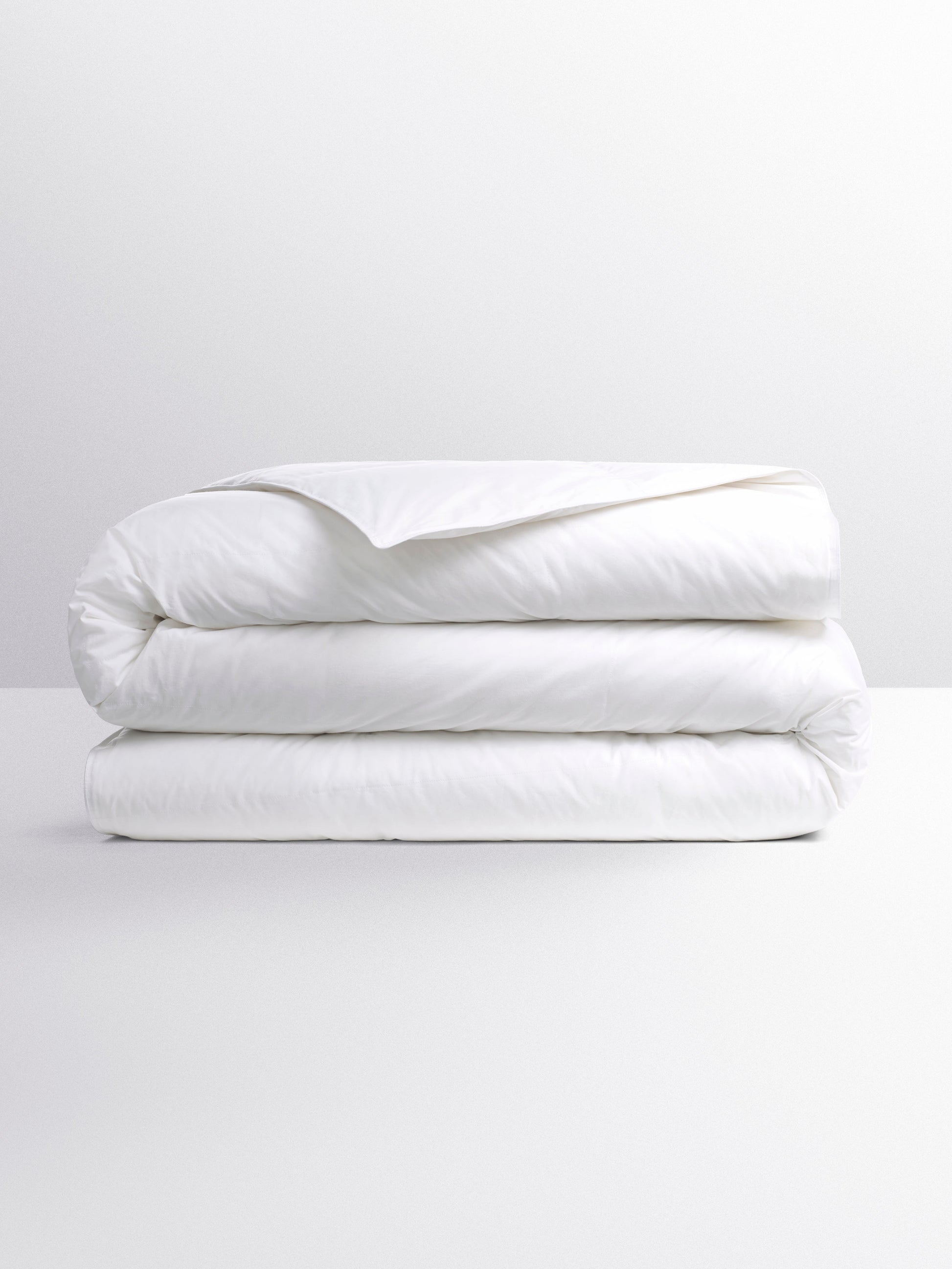 White duvet, folded into three parts on a flat surface.