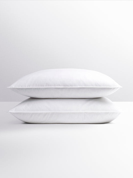 Pair of fluffy white pillows, stacked on top of each other. -{{Signature White}}