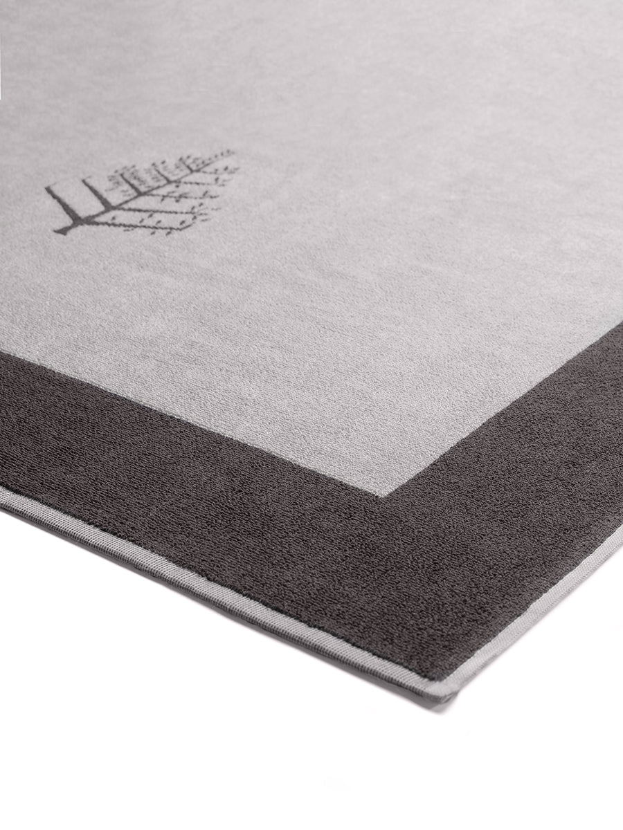 Close-up of a "Hampshire Charcoal" Resort Towel with a subtle embroidered Four Seasons logo. The towel features a darker border - {{Hampshire Charcoal}}