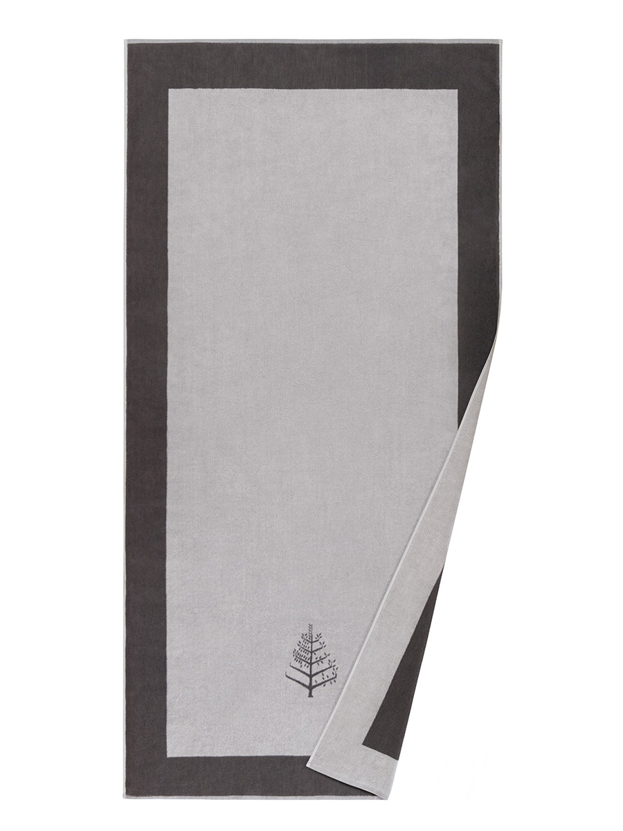 A "Hampshire Charcoal" Resort Towel with a subtle embroidered Four Seasons logo. The towel features a darker border and is folded on a white background. - {{Hampshire Charcoal}}