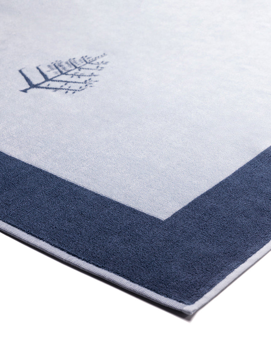 Close-up of a "Maldivian Atoll" Resort Towel with a subtle embroidered Four Seasons logo. The towel features a darker border. - {{Maldivian Atoll}}
