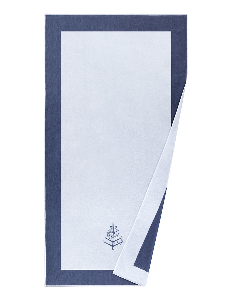 A "Maldivian Atoll" Resort Towel with a subtle embroidered Four Seasons logo. The towel feature a darker "Maldivian Atoll" border and are folded on a white background. - {{Maldivian Atoll}}