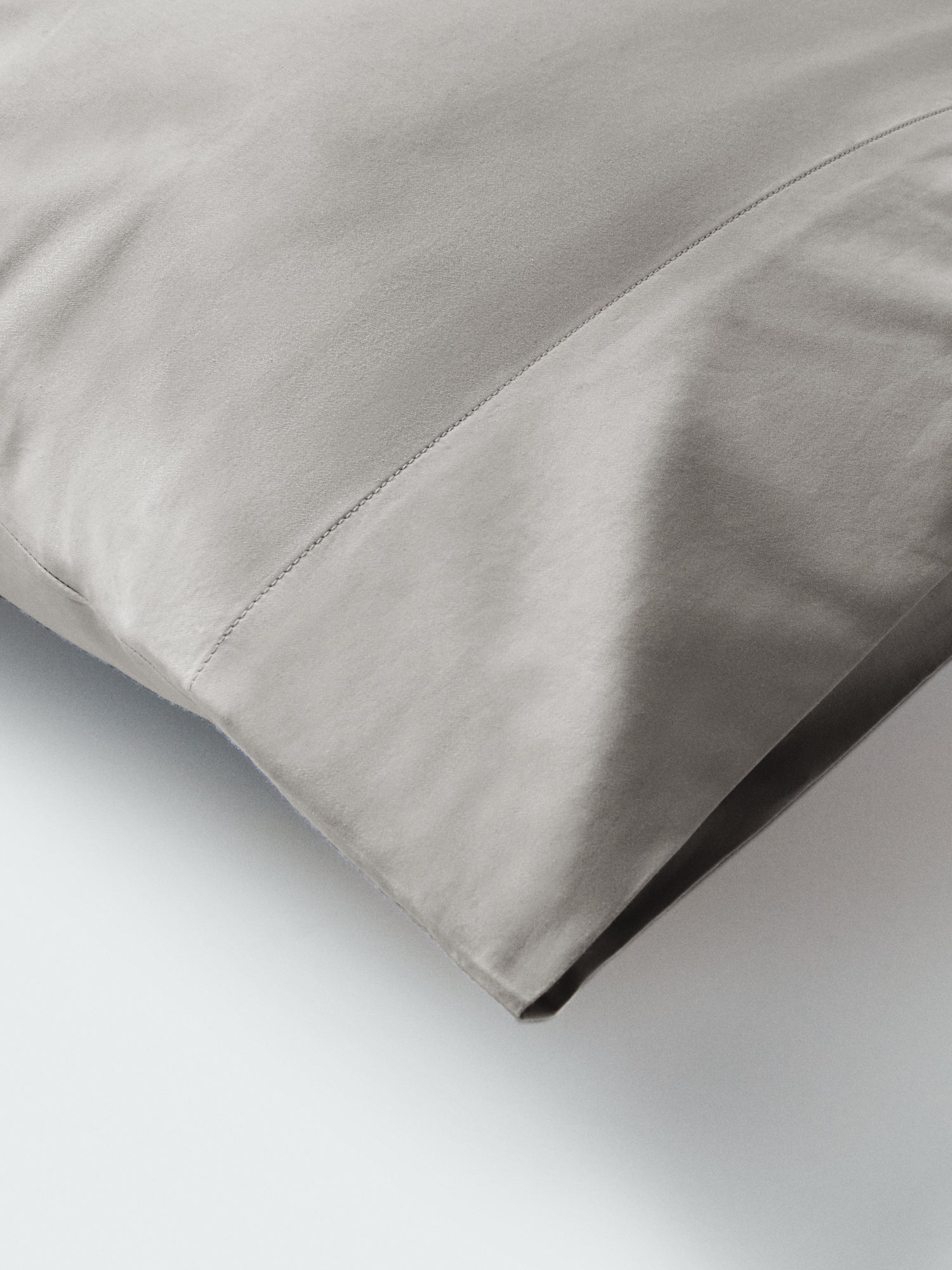 Part of a pillow with a pillowcase in Spanish Slate color. - {{Spanish Slate}}
