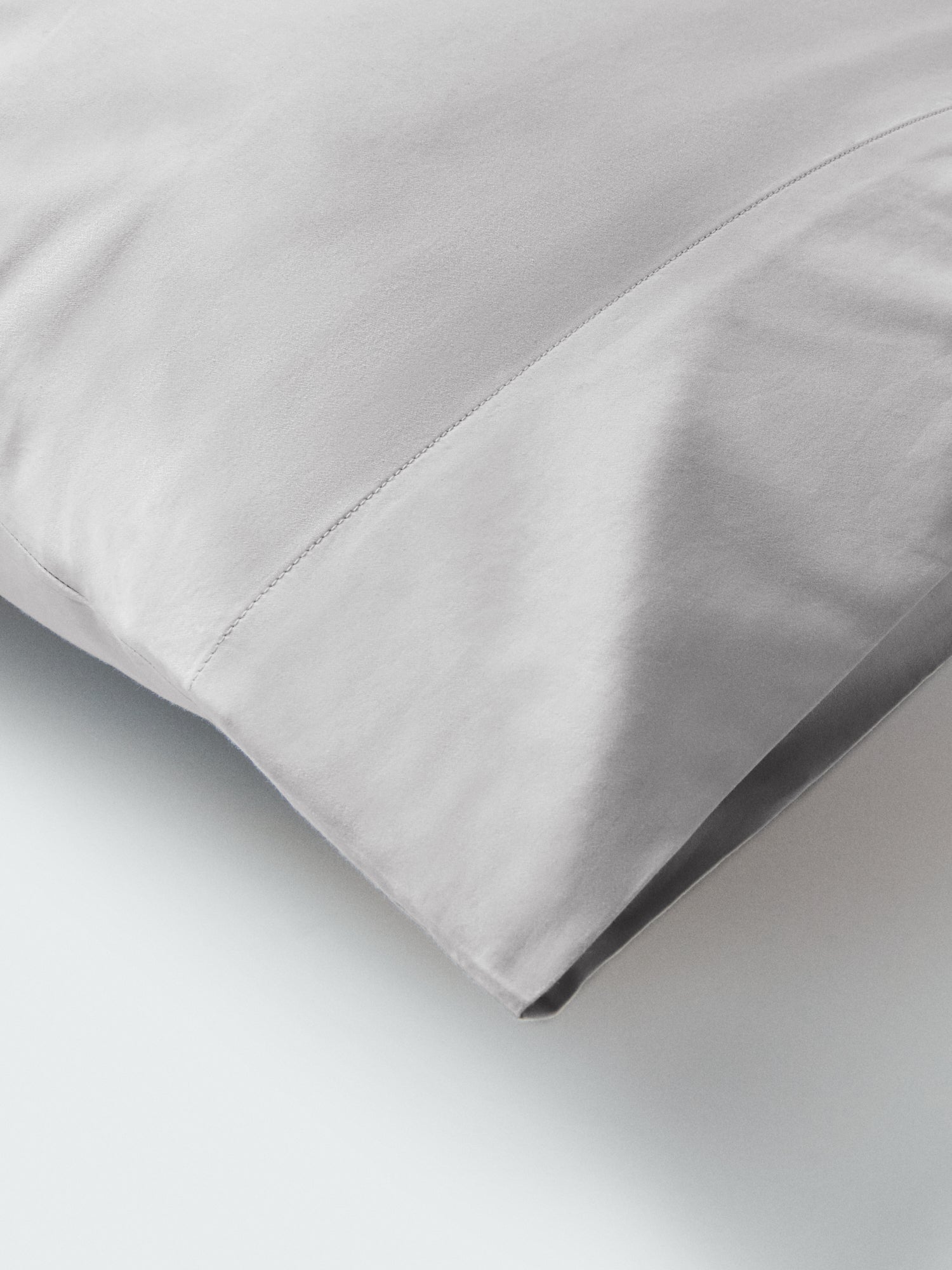 Part of a pillow with a pillowcase in Turkish Silver color. - {{Turkish Silver}}