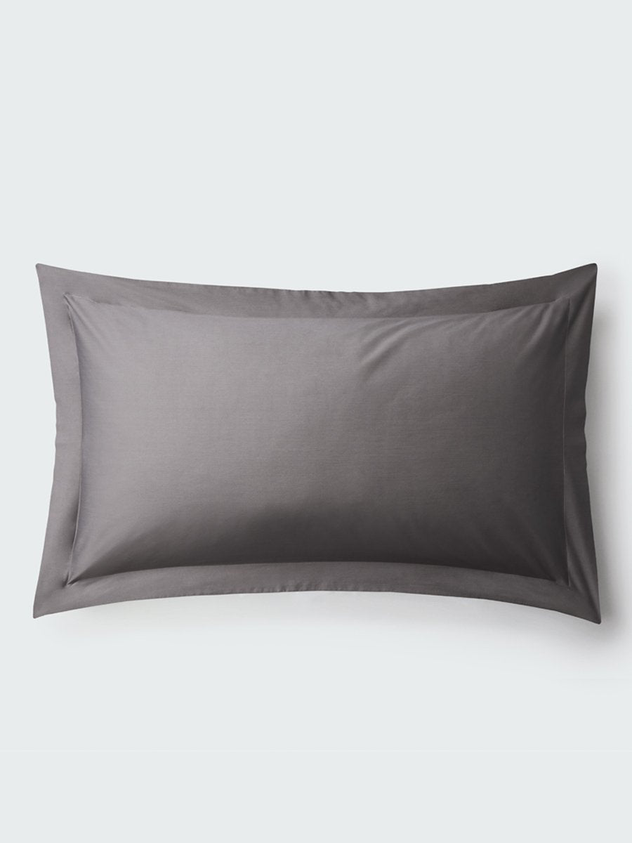 A rectangular pillow with a Hampshire Charcoal color pillowcase, featuring a delicate embroidery that runs along the entire edge. - {{Hampshire Charcoal}}