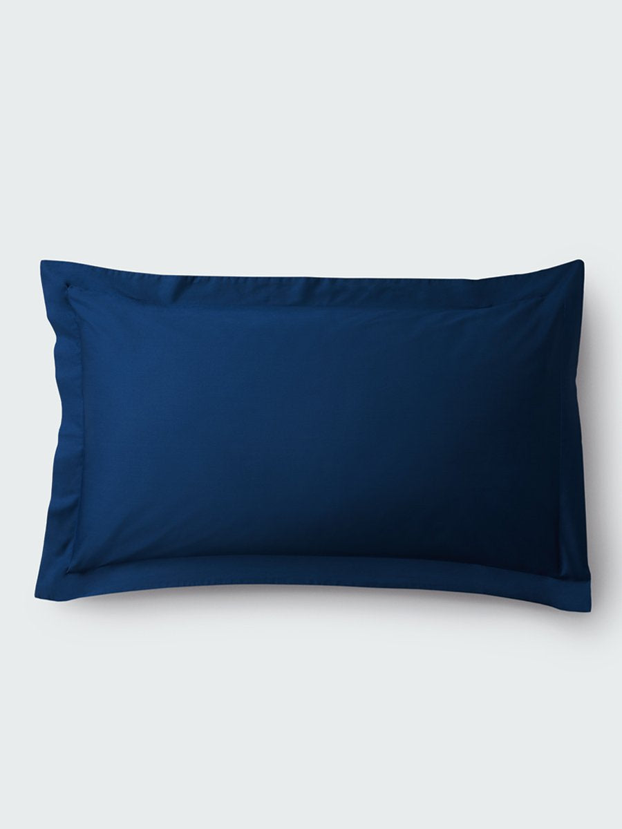 A rectangular pillow with a Riviera Navy color pillowcase, featuring a delicate embroidery that runs along the entire edge. - {{Riviera Navy}}
