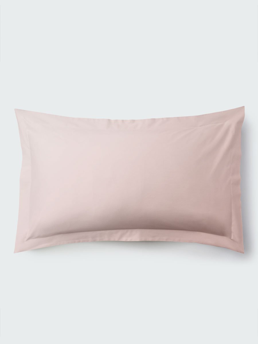 A rectangular pillow with a Kyoto Blush color pillowcase, featuring a delicate embroidery that runs along the entire edge. - {{Kyoto Blush}}