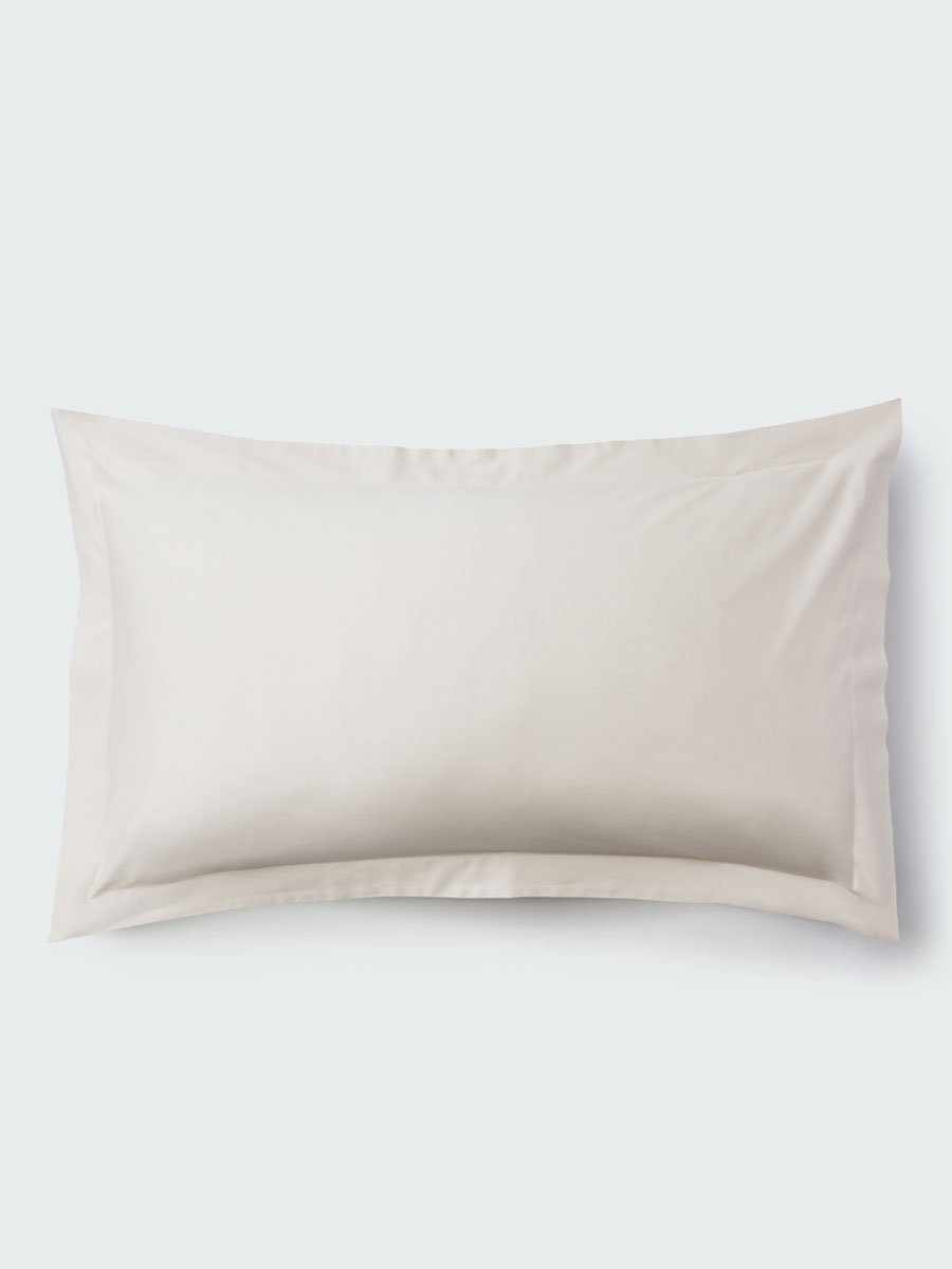 A rectangular pillow with a Balinese Pearl color pillowcase, featuring a delicate embroidery that runs along the entire edge. - {{Balinese Pearl}}