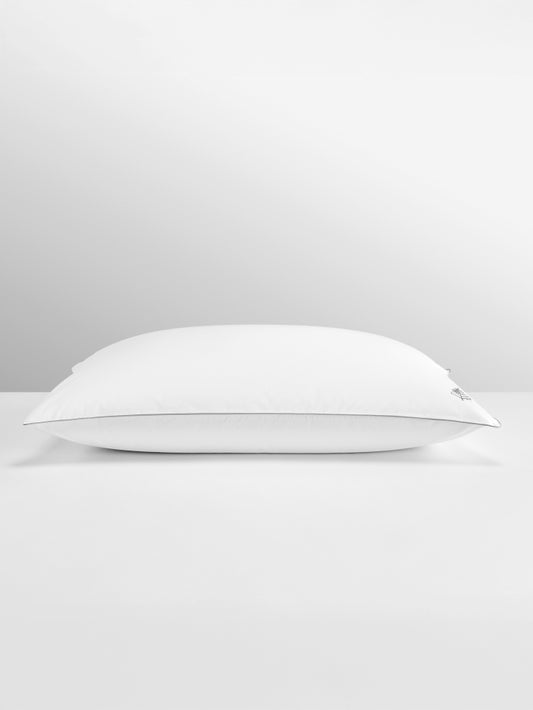 Pure down pillow flatlay image on a grey background.