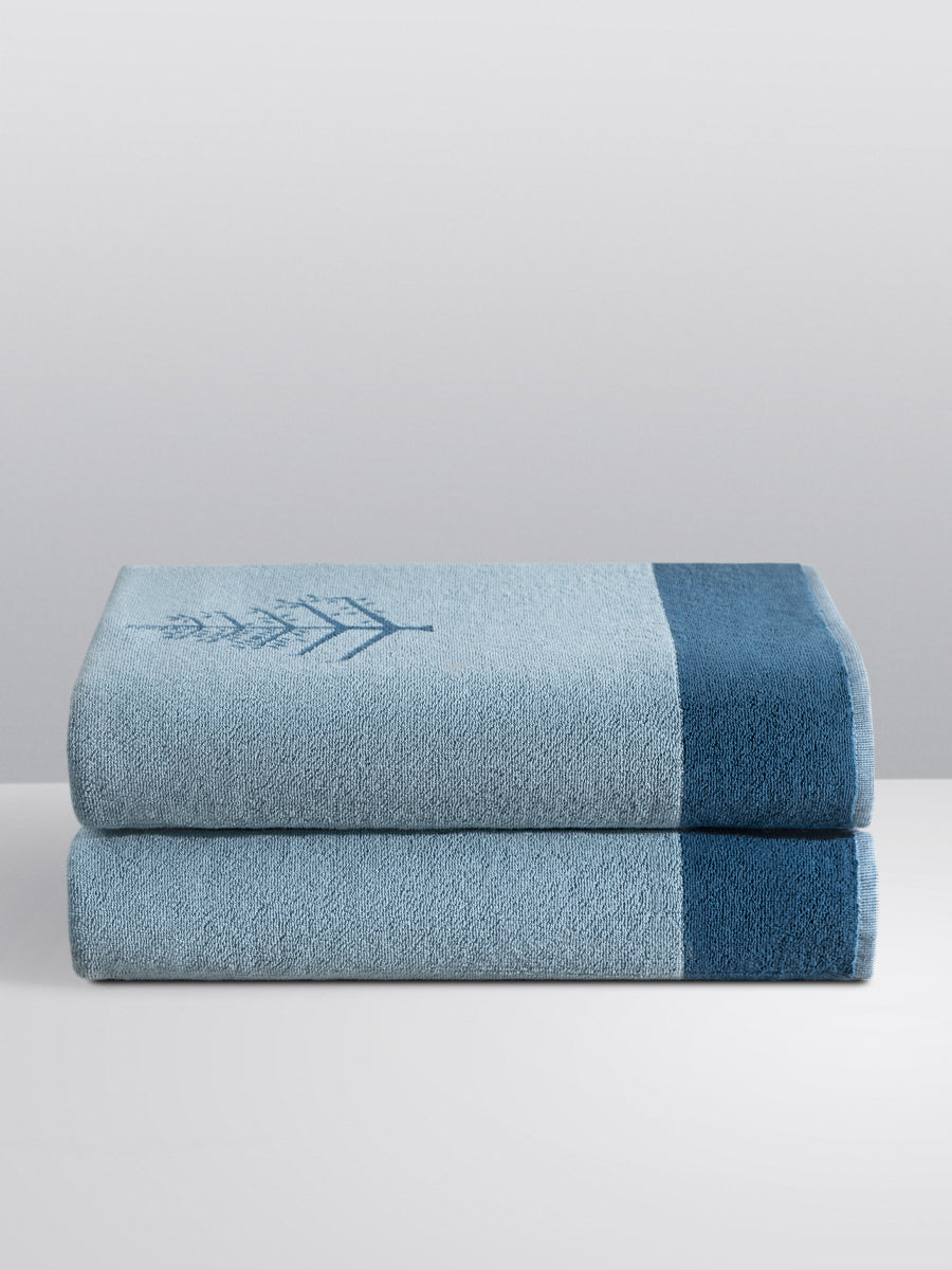 A "Polynesian Lagoon" Resort Towel with a subtle embroidered Four Seasons logo. The towel feature a darker "Polynesian Lagoon" border. - {{Polynesian Lagoon}}