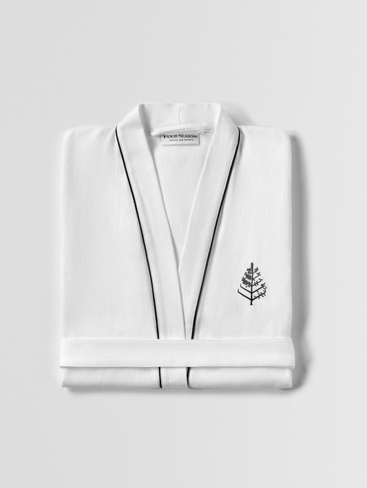 Resort Robe, folded—white waffle fabric with black piping and an embroidered Four Seasons tree logo at the left chest.