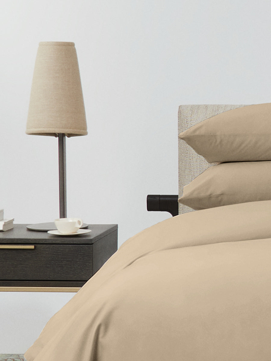 Bed dressed with a duvet in Egyptian Camel color and two matching pillows. - {{Egyptian Camel}}