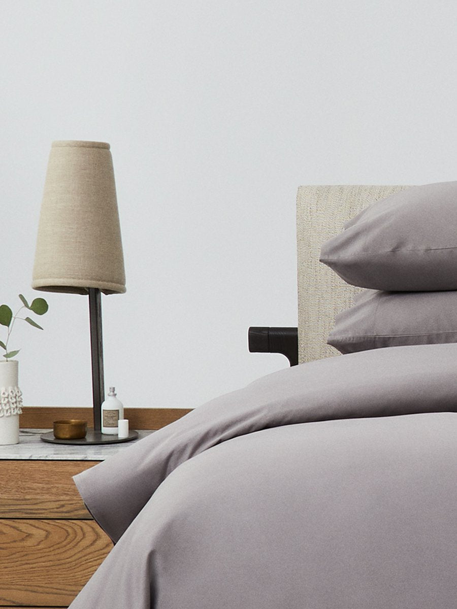 Bed dressed with a duvet in 'Hampshire Charcoal' color and two matching pillows. - {{Hampshire Charcoal}}