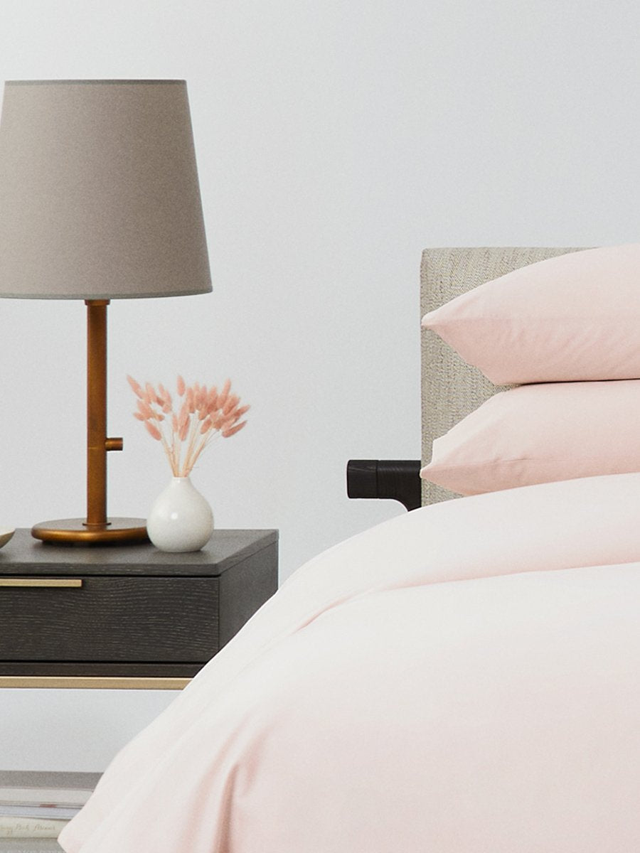 Bed dressed with a duvet in Kyoto Blush color and two matching pillows. - {{Kyoto Blush}}