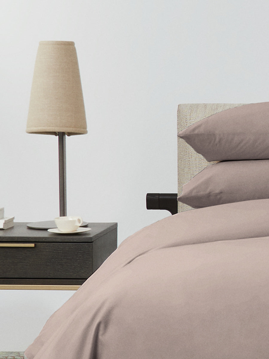 Bed dressed with a duvet in Moroccan Sand color and two matching pillows. - {{Moroccan Sand}}