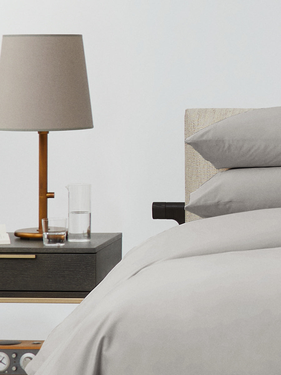 Bed dressed with a duvet in Spanish Slate color and two matching pillows. - {{Spanish Slate}}