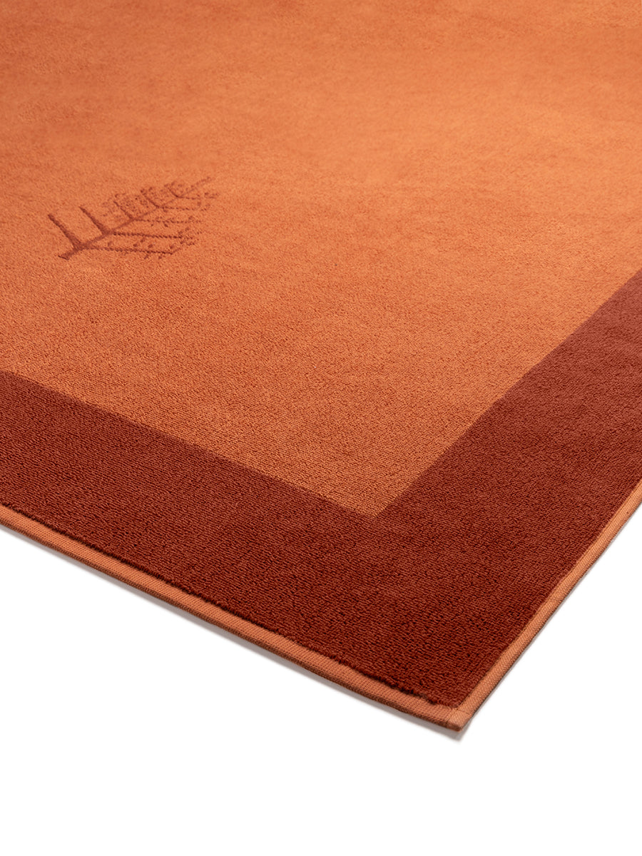 Close-up of a "Sicilian Dawn" Resort Towel with a subtle embroidered Four Seasons logo. The towel features a darker border. - {{Sicilian Dawn}}