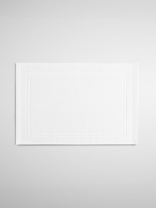 Four Seasons Woven Bath Mat, intricate Swiss dot design, low profile, perfect for bath rituals {{White}}