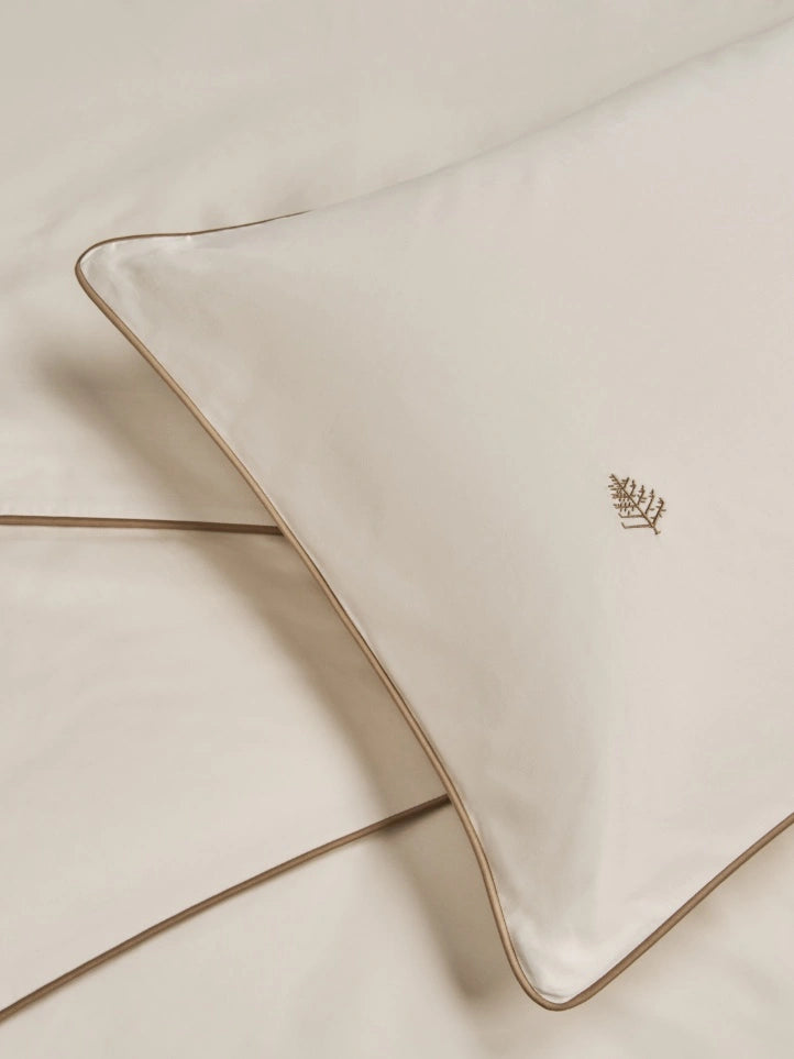 Two Sycamore balinese pearl pillows with tan trim. {{Balinese Pearl}}