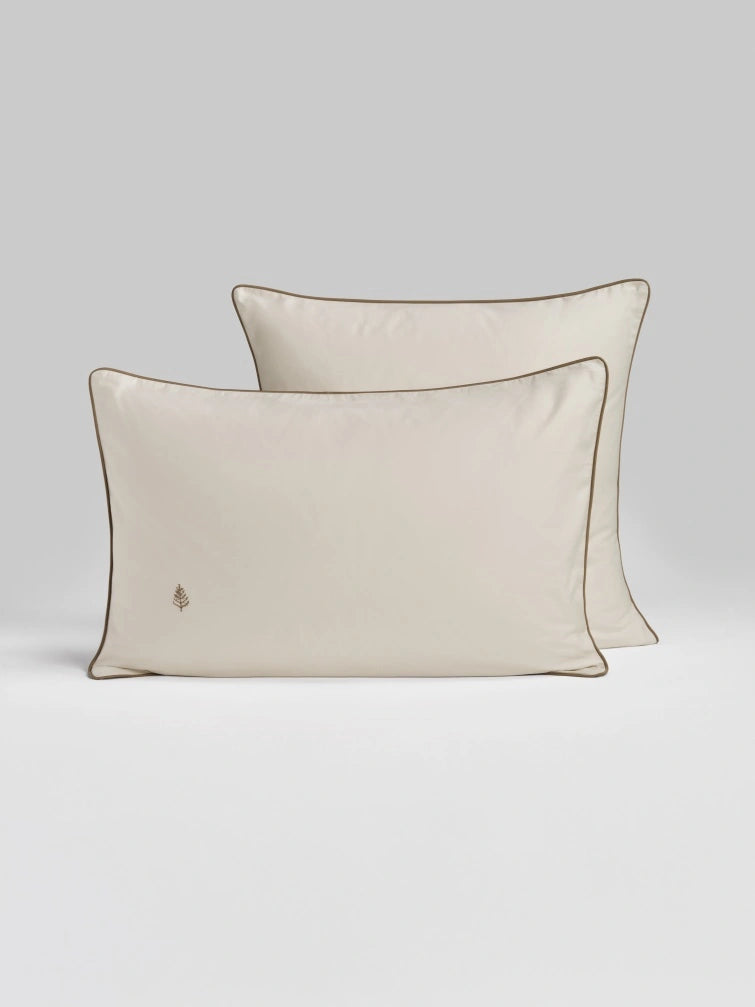 Two Sycamore balinese pearl pillows with tan trim. {{Balinese Pearl}}