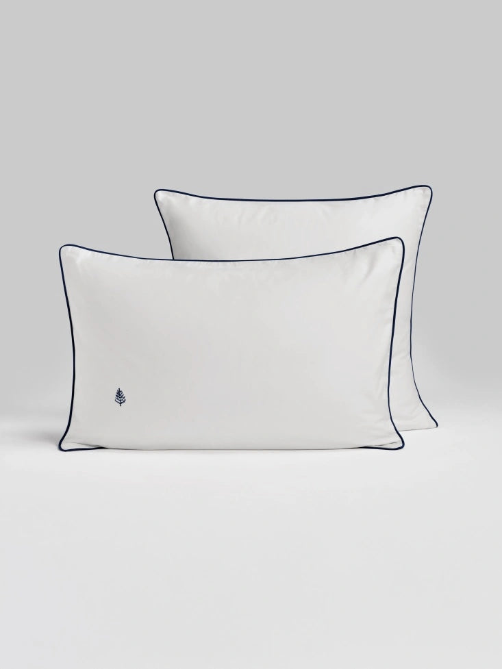 Two Sycamore signautre white pillows with navy trim. {{Signature White}}