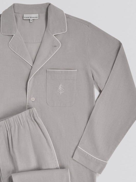 Gray pajama set with a small embroidered design on a light gray background