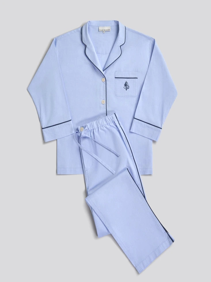 Light blue pajama set with a Four Seasons Logo embroidered design on the front pocket and navy piping on hem.